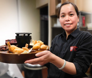Friendly server with delicious shrimp and barbecue at Chen Chinese Cuisine Restaurant